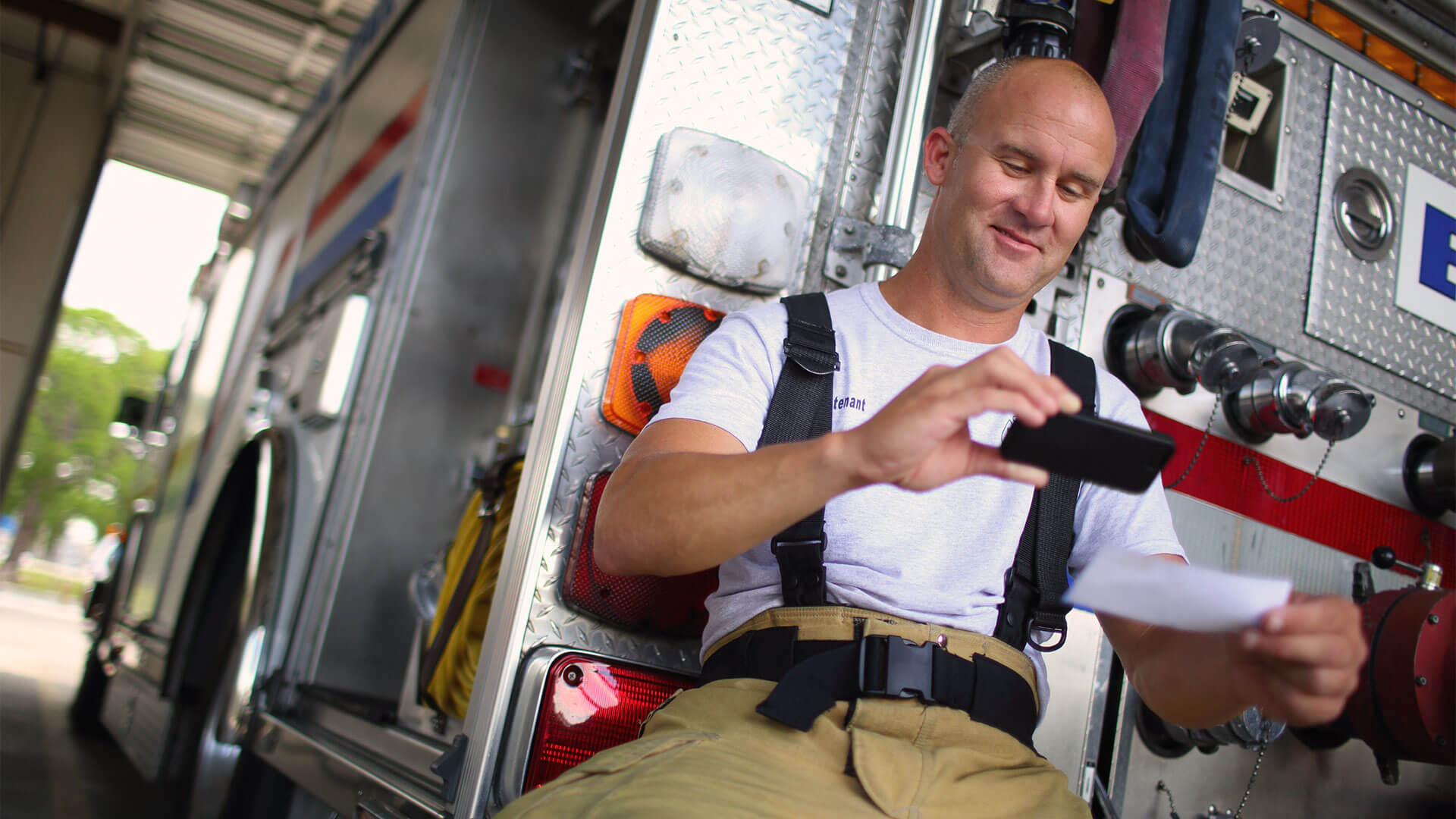 Firefighter using mobile banking.